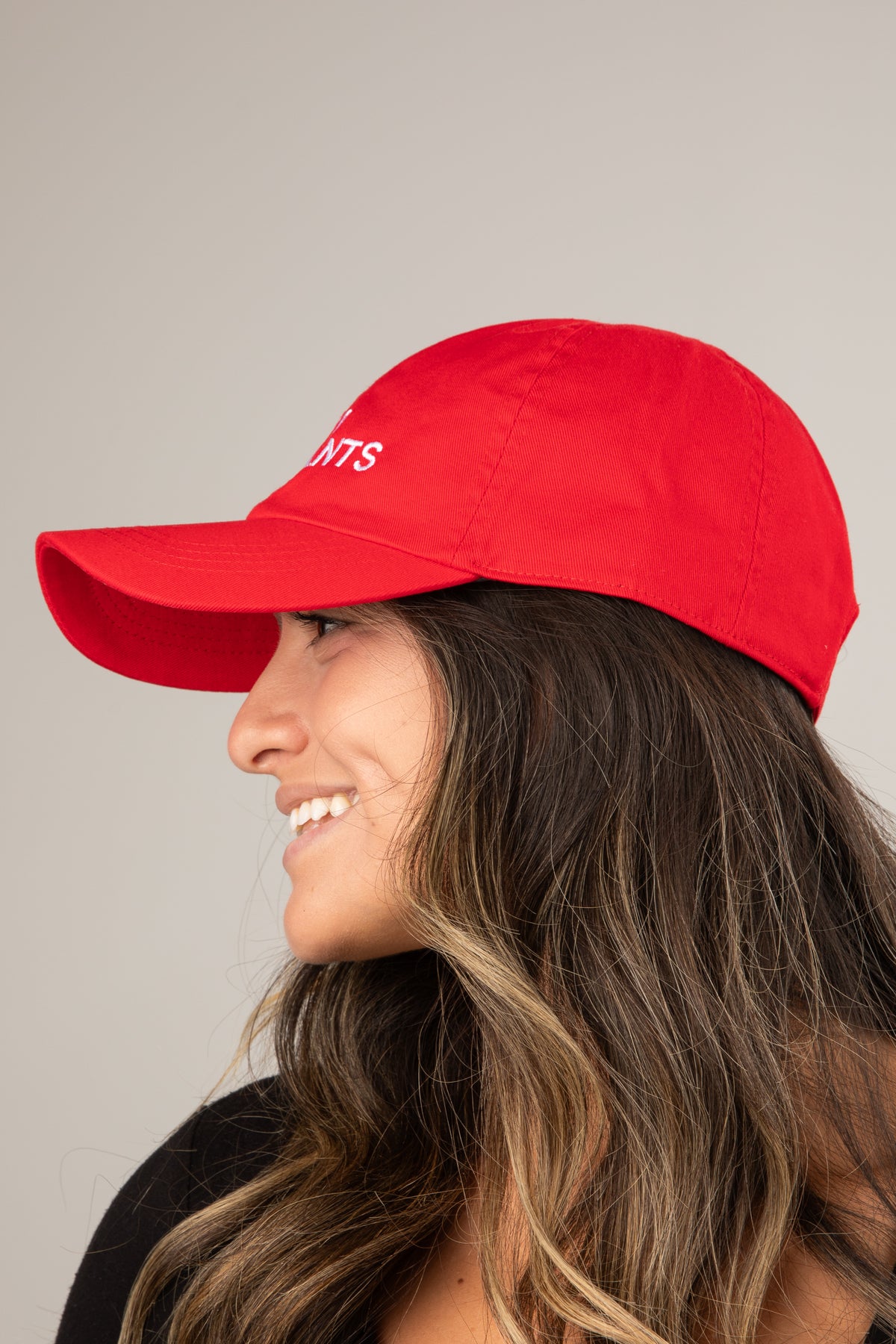 Woman wearing a red cap with &