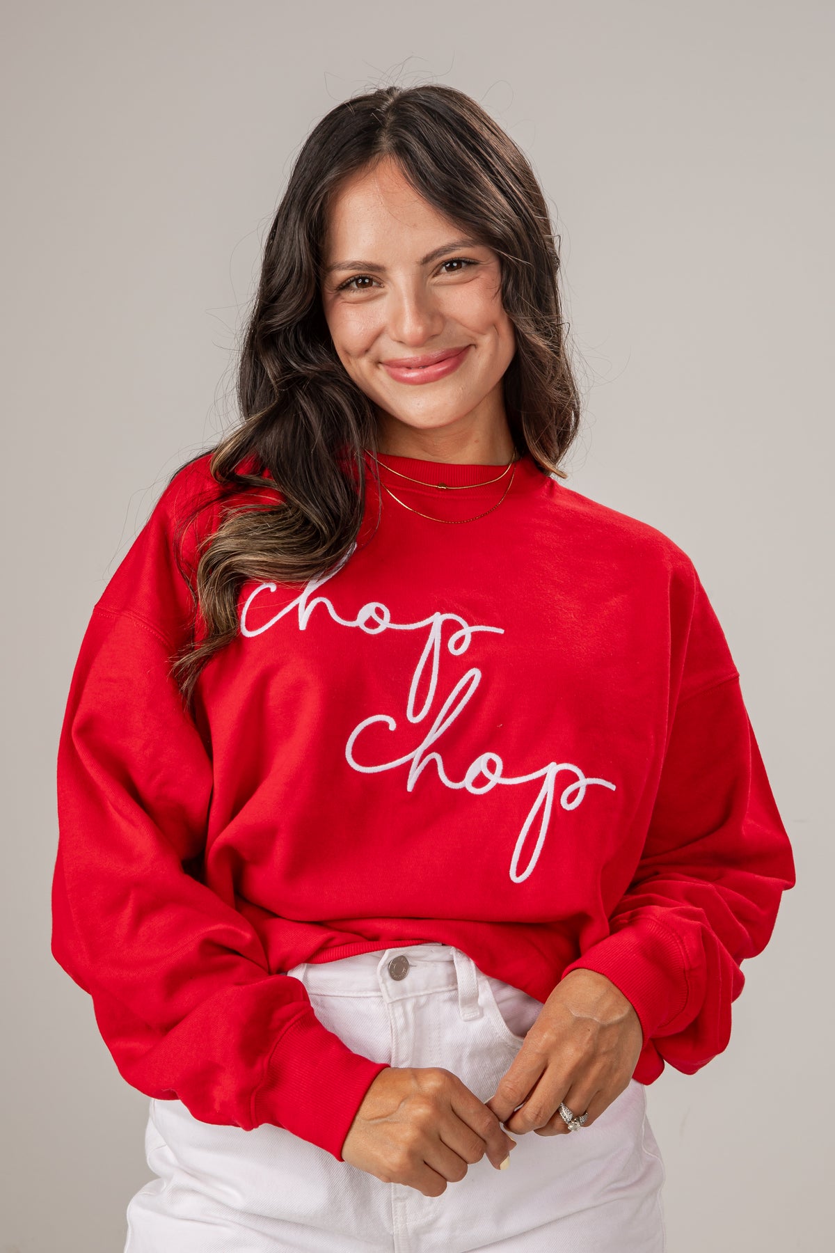 Woman wearing a red sweatshirt with &