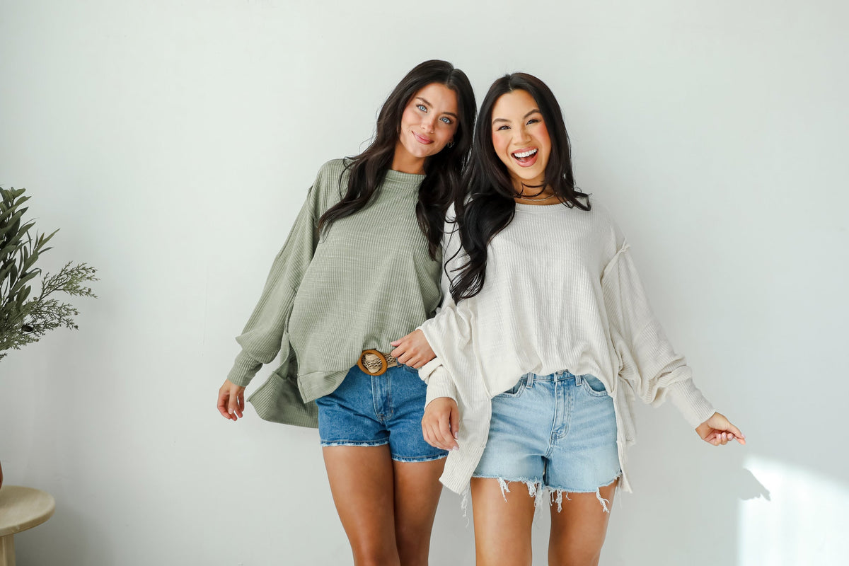2 models wearing lightweight knit sweaters