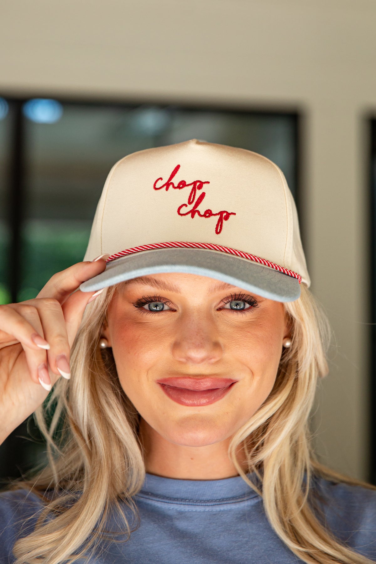 Person wearing a beige cap with &