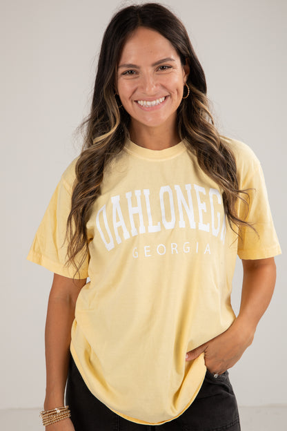 Woman wearing a yellow t-shirt with &