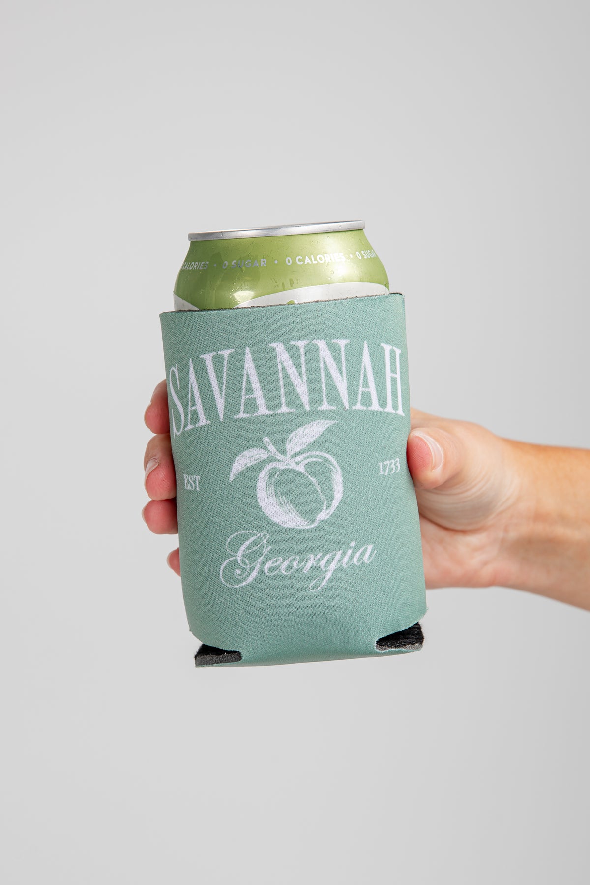 Hand holding a can with a &
