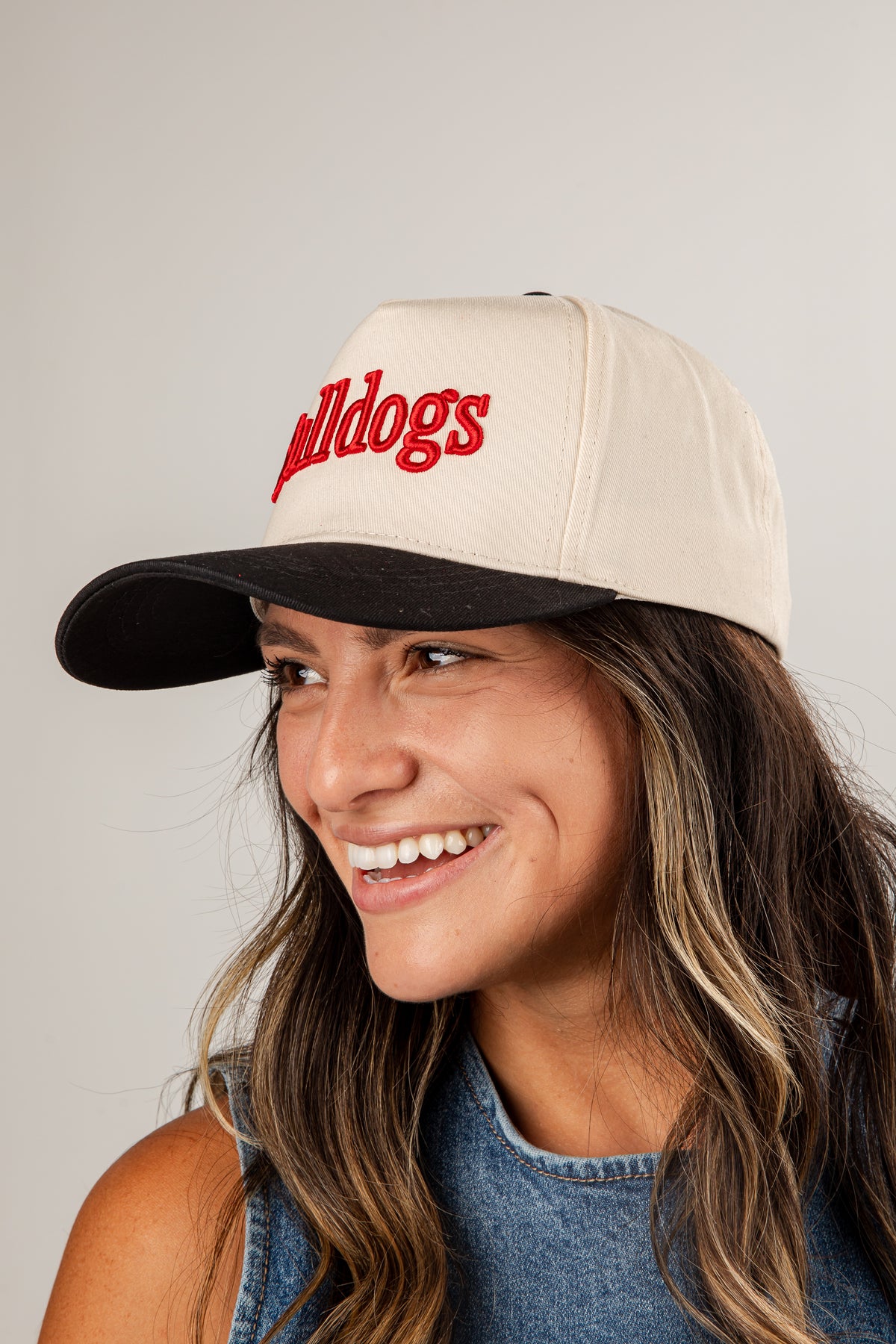 Woman wearing a beige cap with &