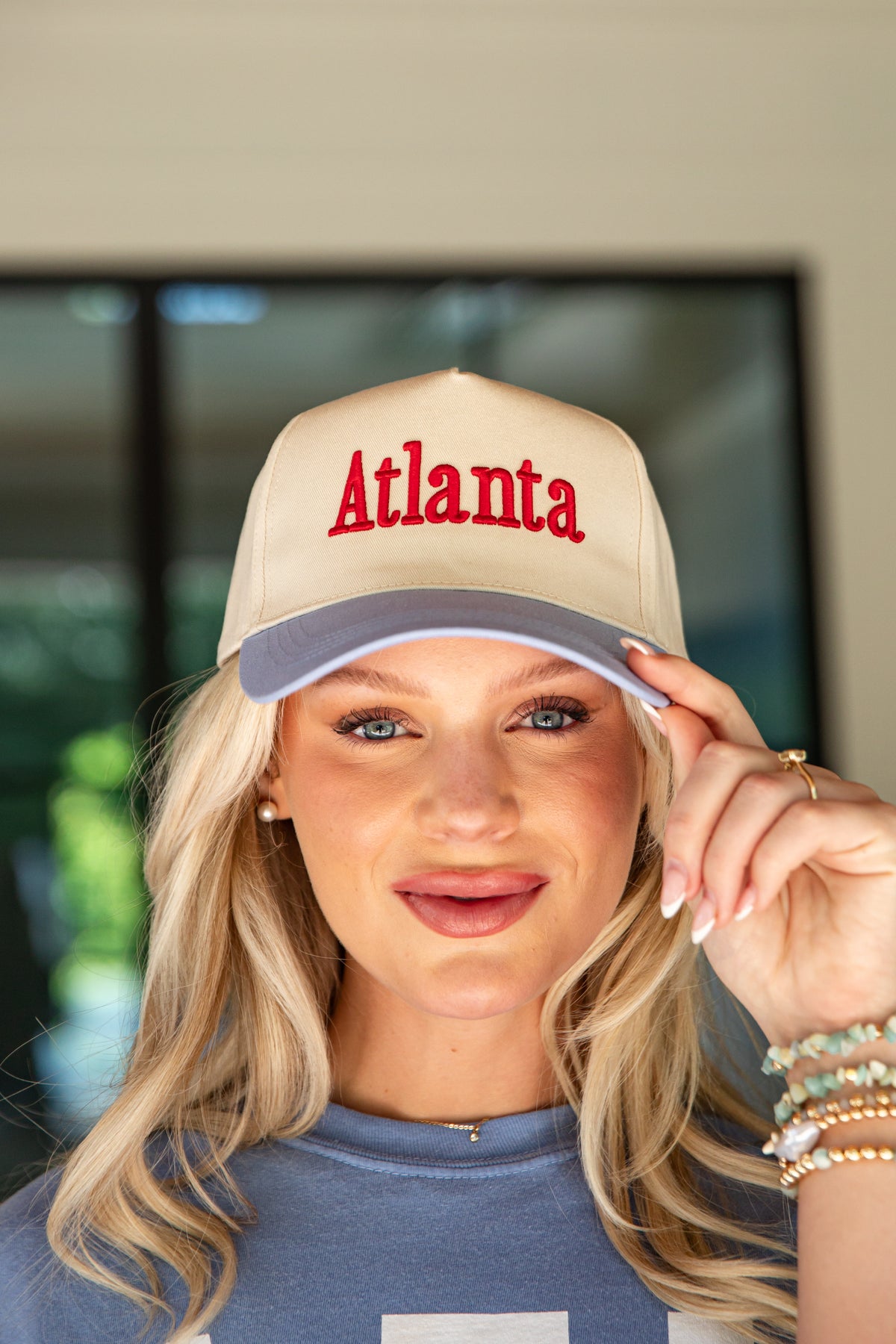 Woman wearing a beige cap with &