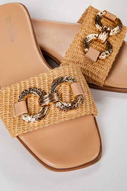 Tan woven sandals with gold chain detail on a light gray background