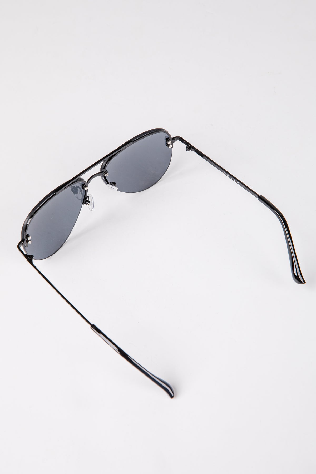 Sunglasses with black frames and reflective lenses on a white background