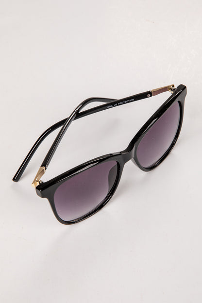 Black cat-eye sunglasses with gold accents on a white background