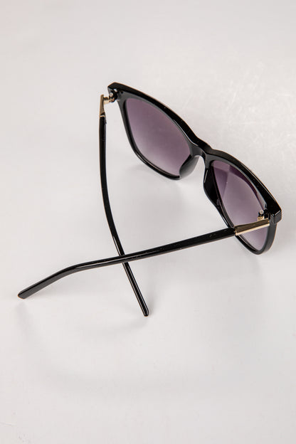 Black sunglasses with purple lenses on a white background