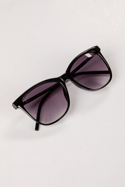 Black sunglasses with purple lenses on a white background