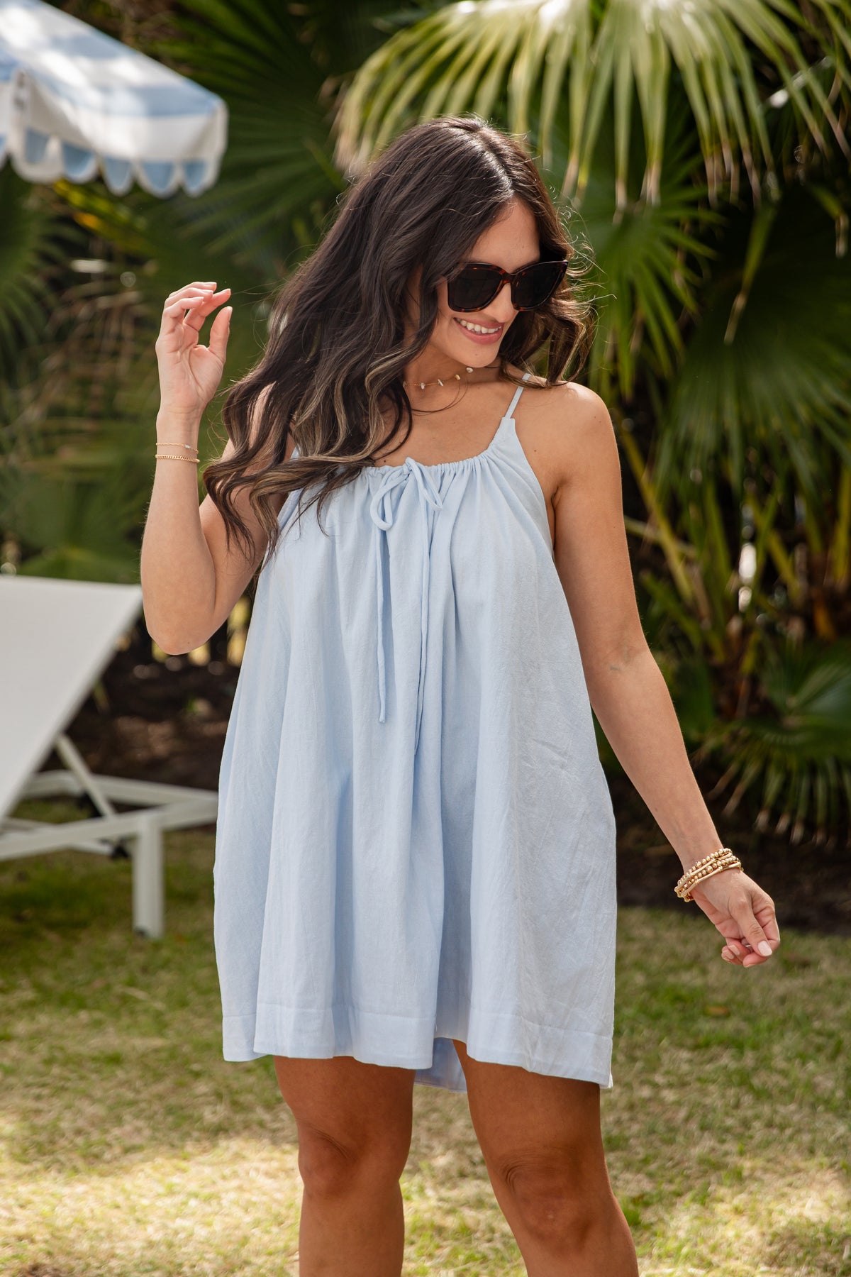 Woman wearing a light blue dress in a garden setting