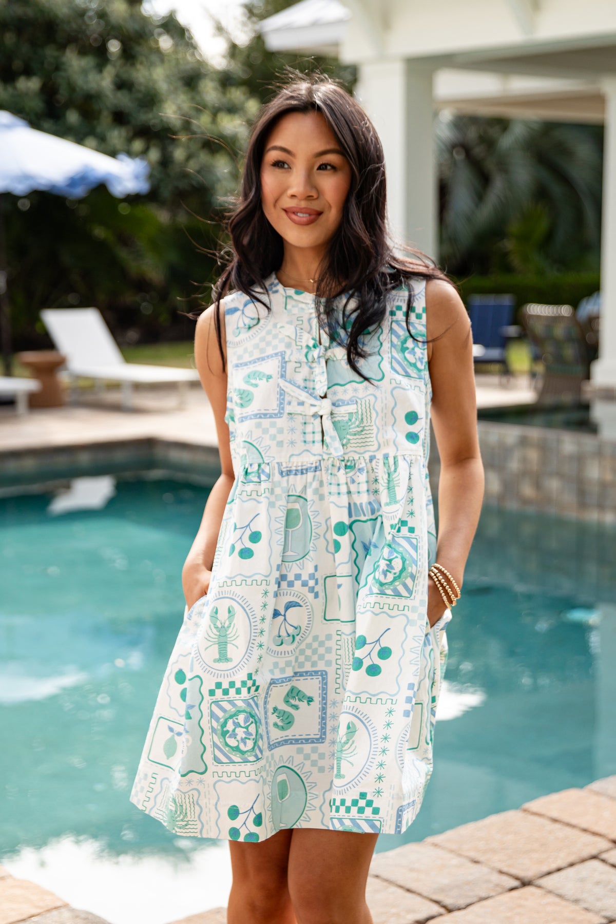 Woman wearing a patterned dress by a poolside