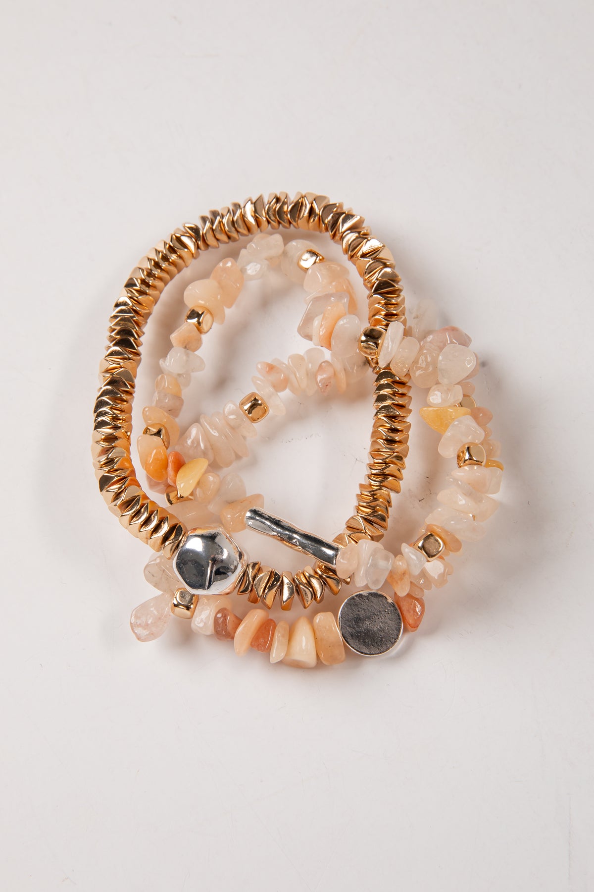 Decorative brooch with gold and silver accents on a white background