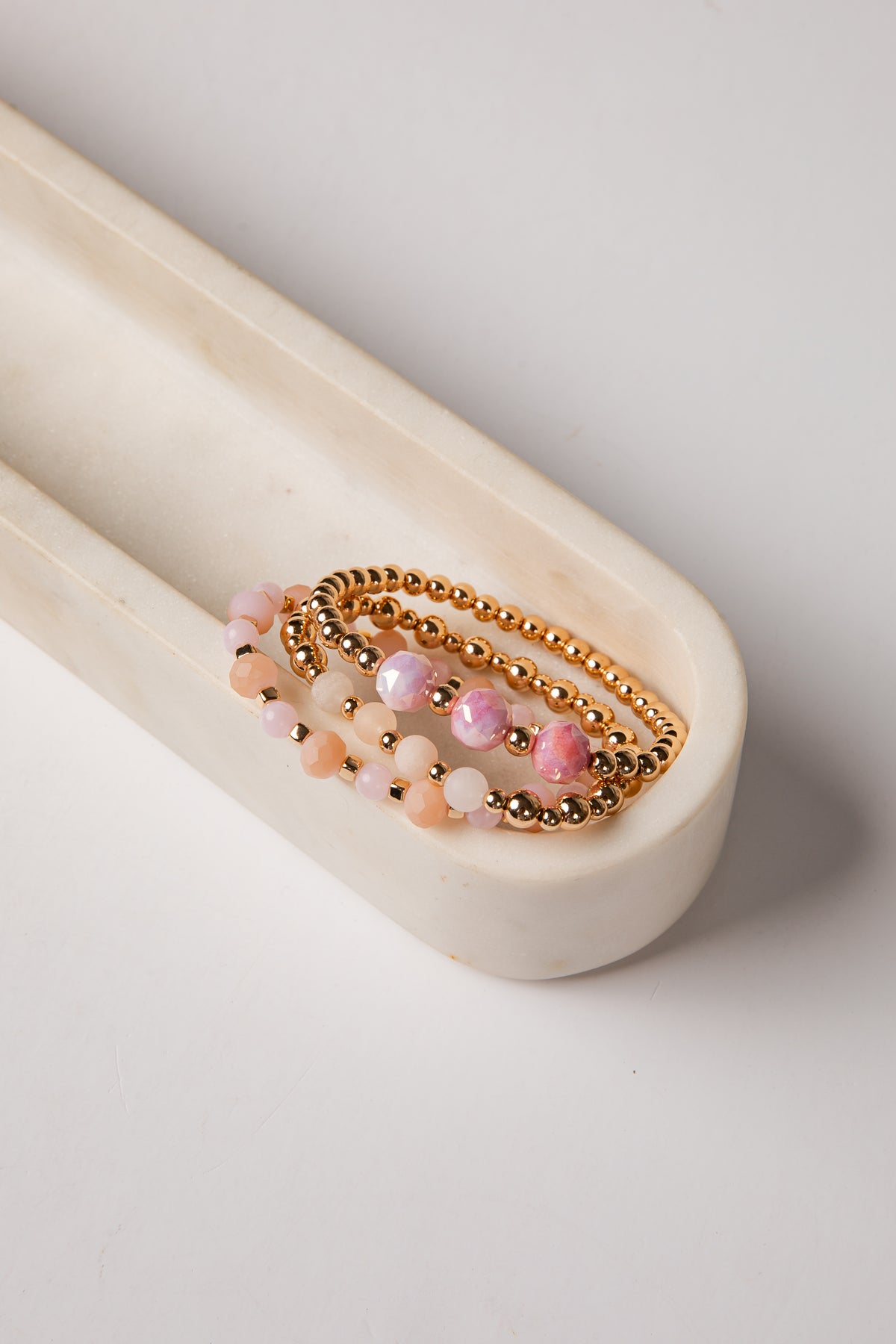 Set of beaded bracelets on a white surface