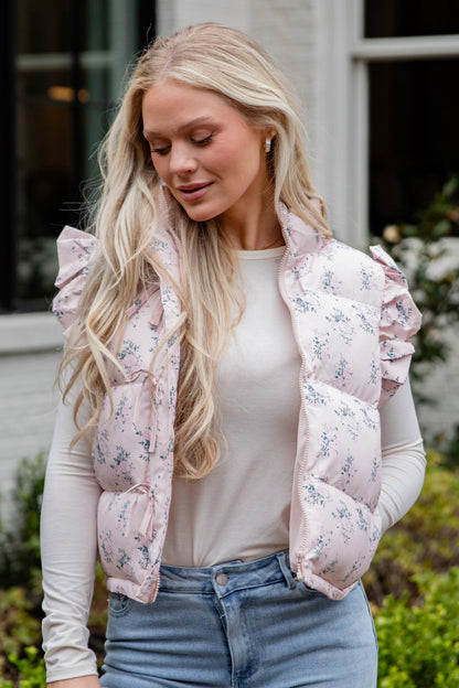Woman wearing a floral puffer vest outdoors