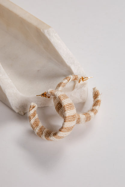 Pair of striped hoop earrings on a light background