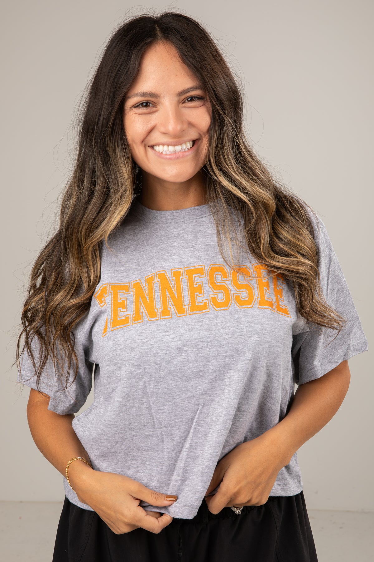 Woman wearing a gray t-shirt with &