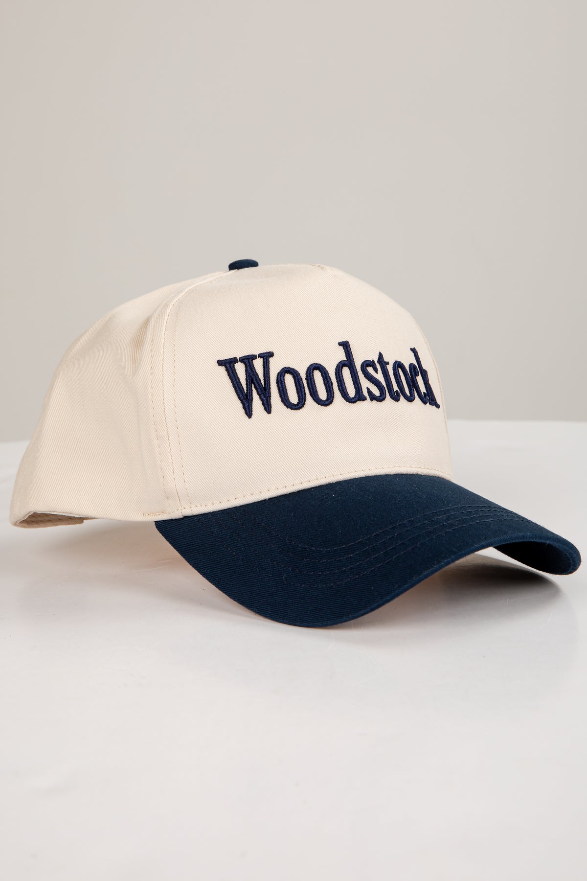 Beige and navy cap with &