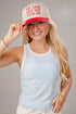Woman wearing a red and white cap with text and a light blue tank top with &