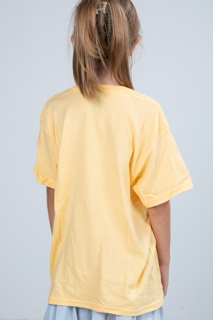 Person wearing a yellow t-shirt on a plain background