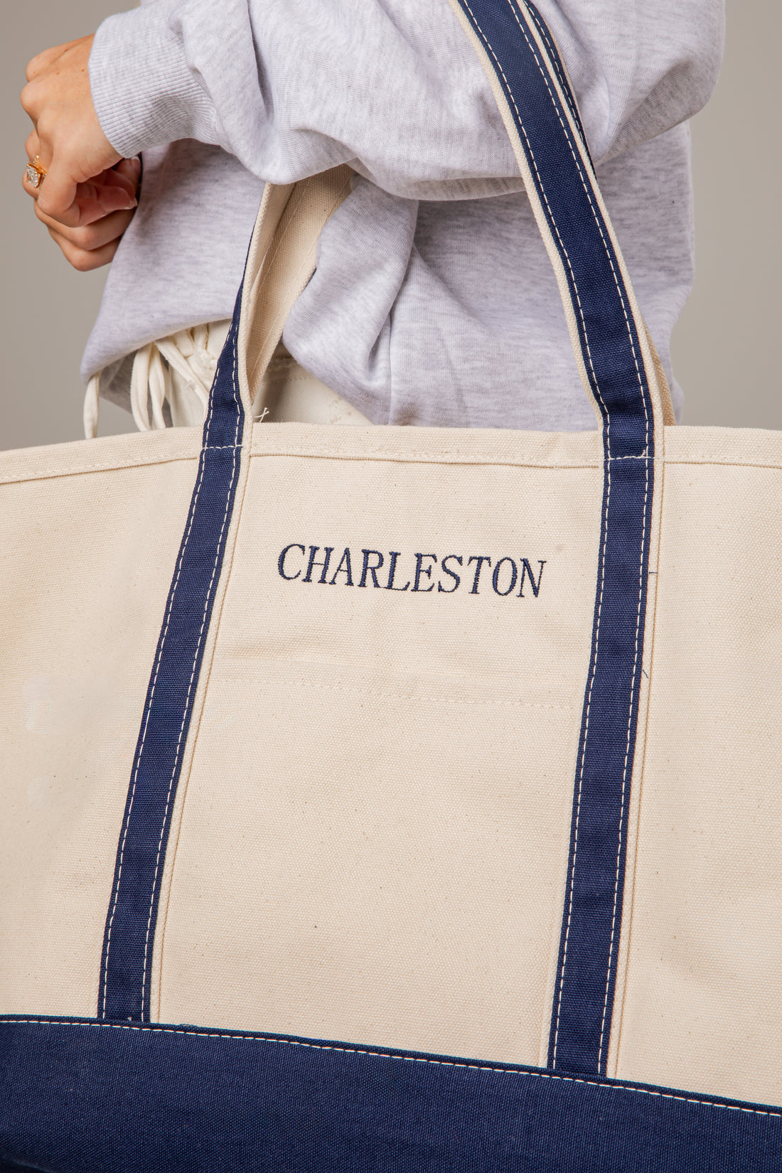 Beige tote bag with navy accents and &