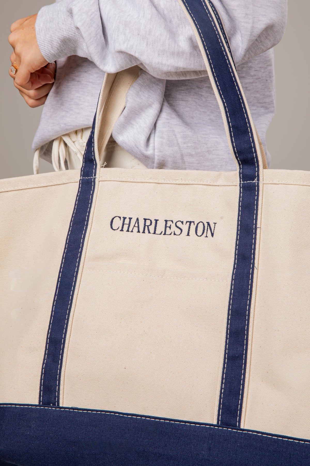 Beige tote bag with navy accents and &