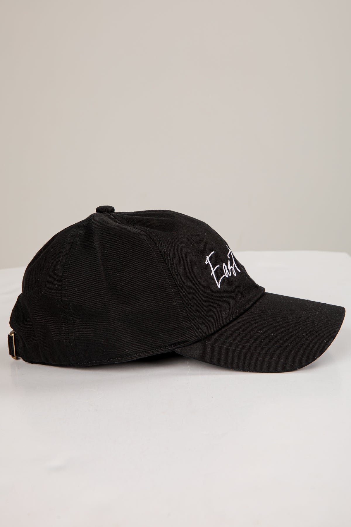 Black cap with white text on a white background