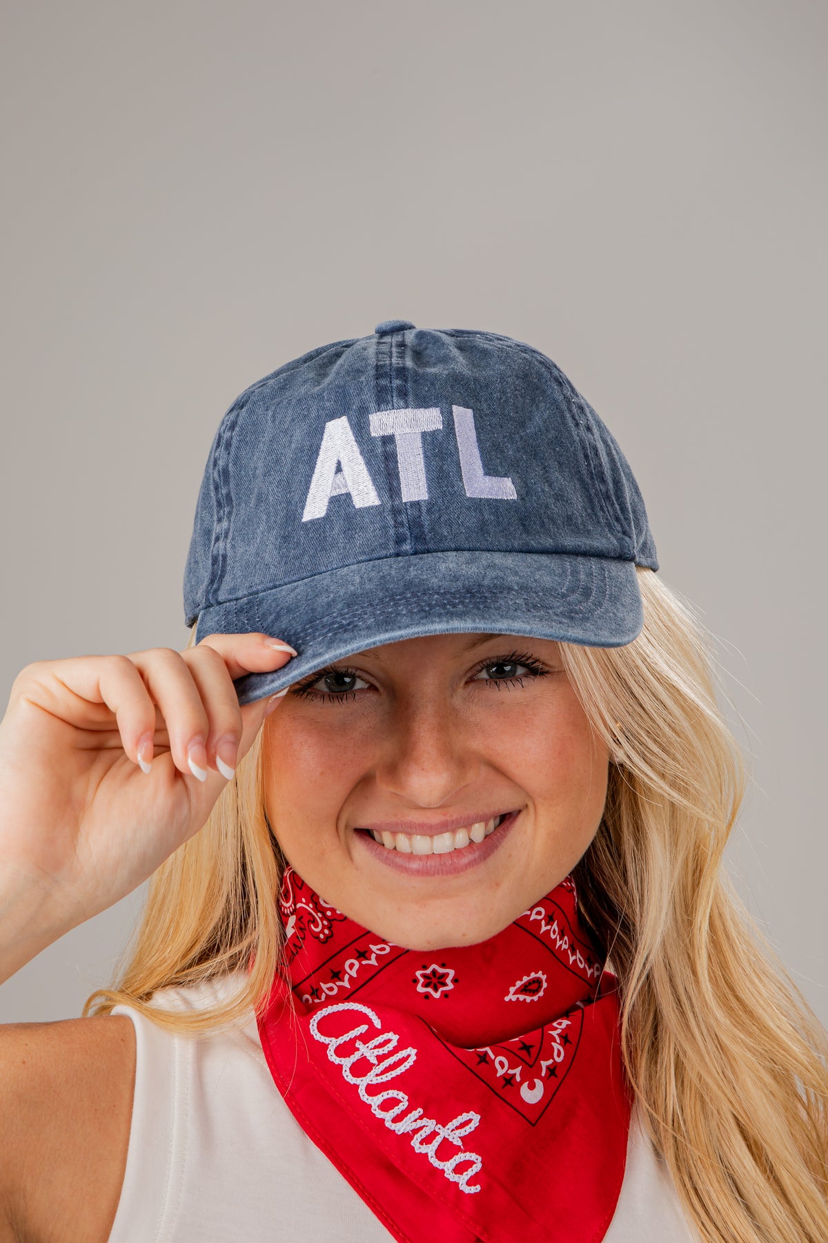 Person wearing a denim cap with &