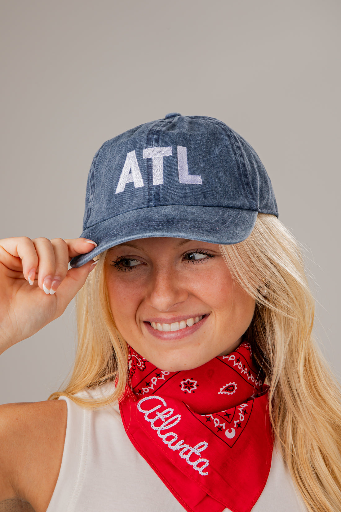 Person wearing a denim cap with &