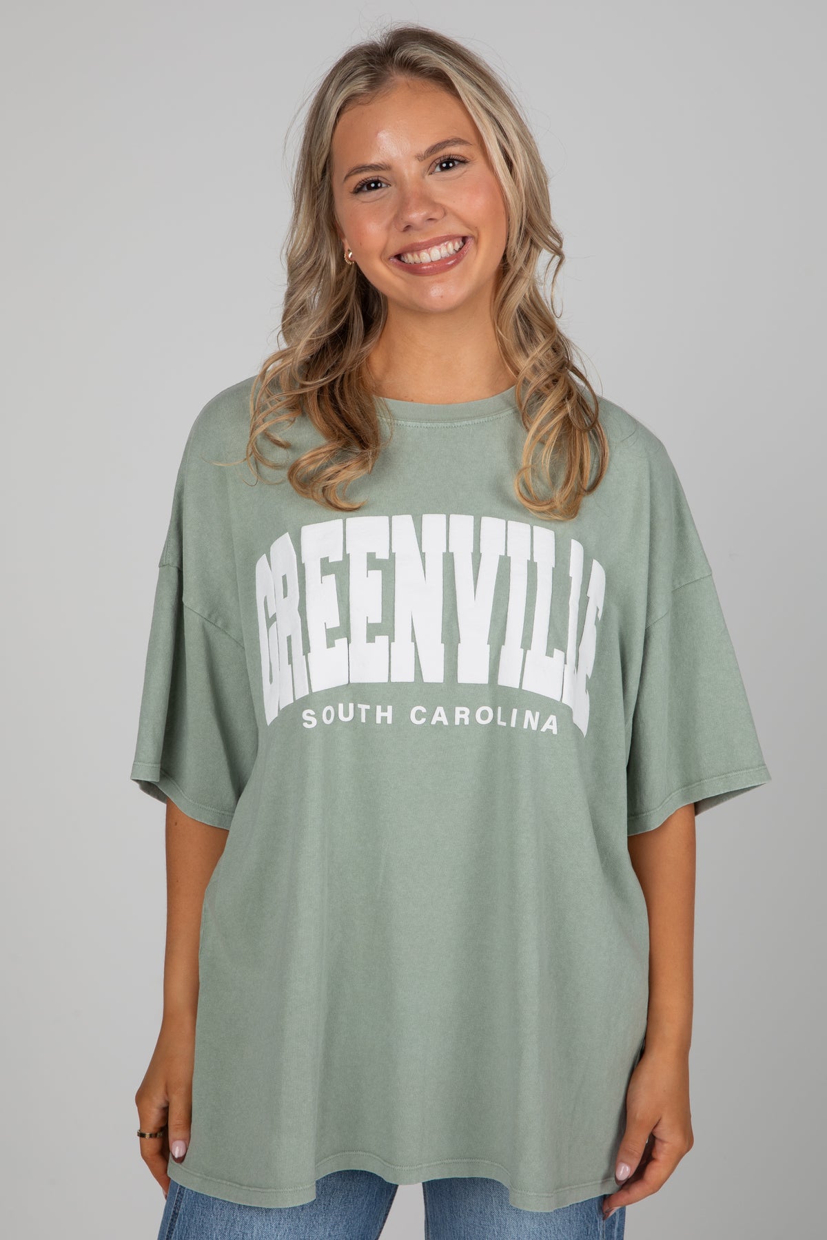 Woman wearing a green t-shirt with &