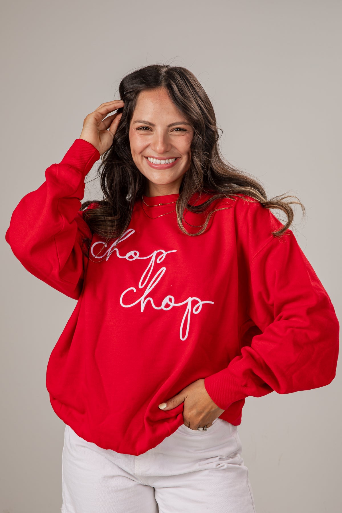 Woman wearing a red sweatshirt with &