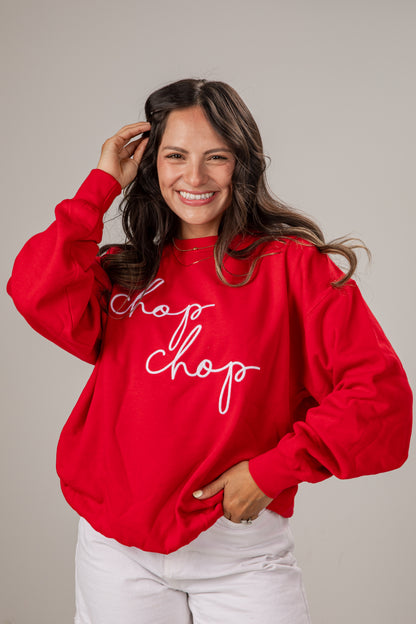 Woman wearing a red sweatshirt with &