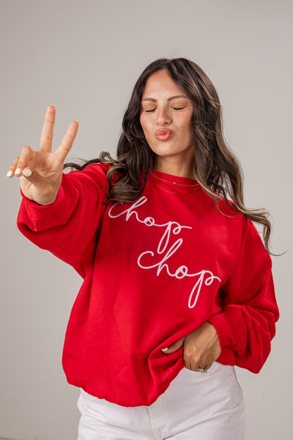 Woman wearing a red sweatshirt with &
