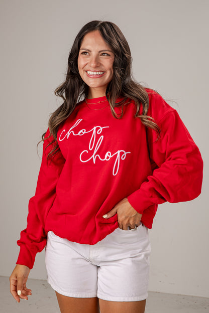 Woman wearing a red sweatshirt with &