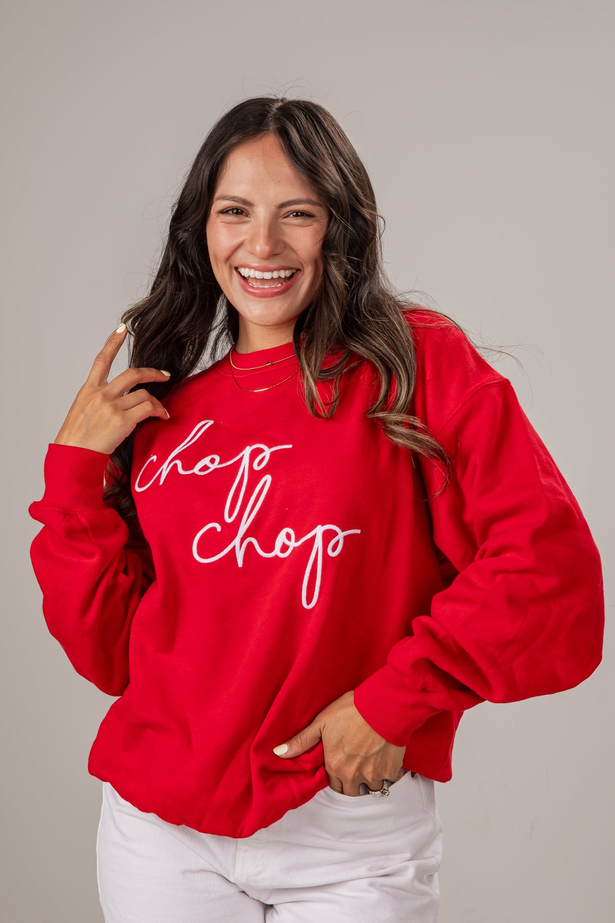 Woman wearing a red sweatshirt with &