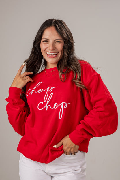 Woman wearing a red sweatshirt with &