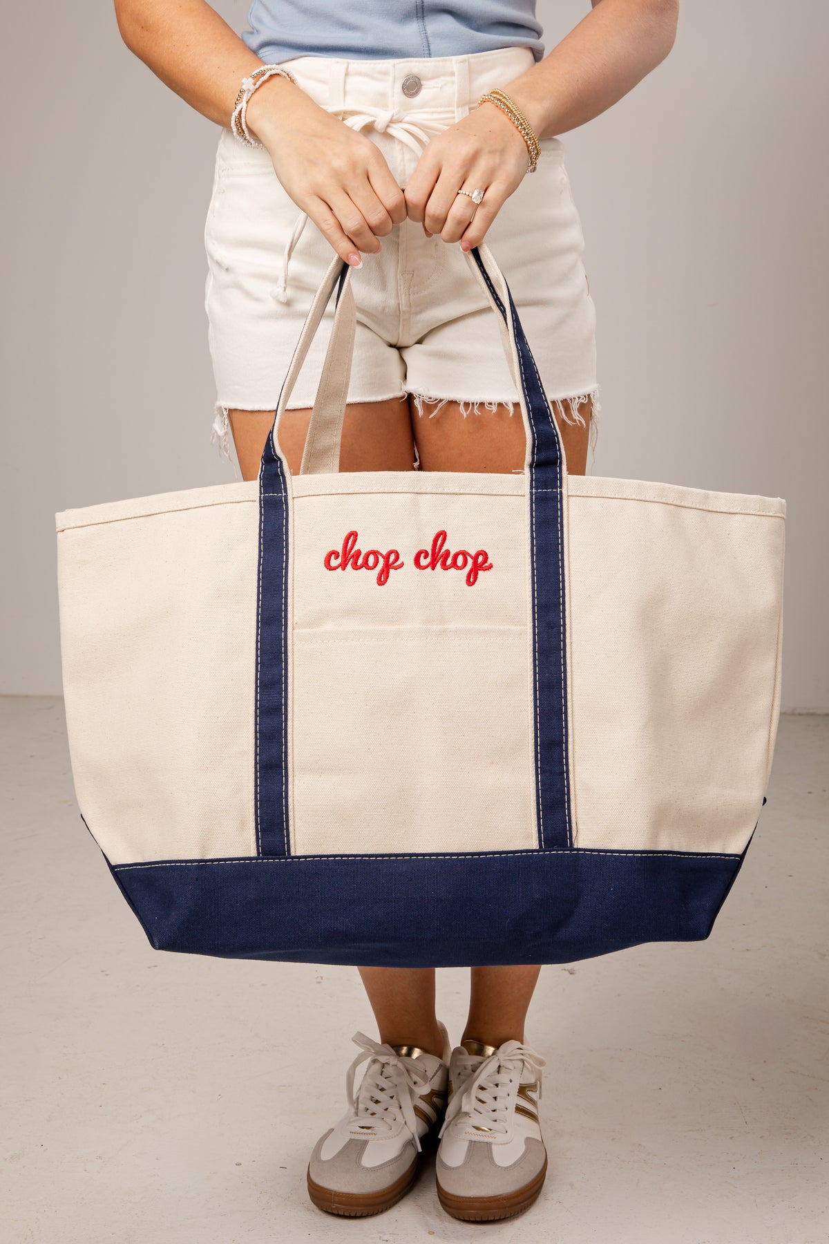 Person holding a tote bag with &