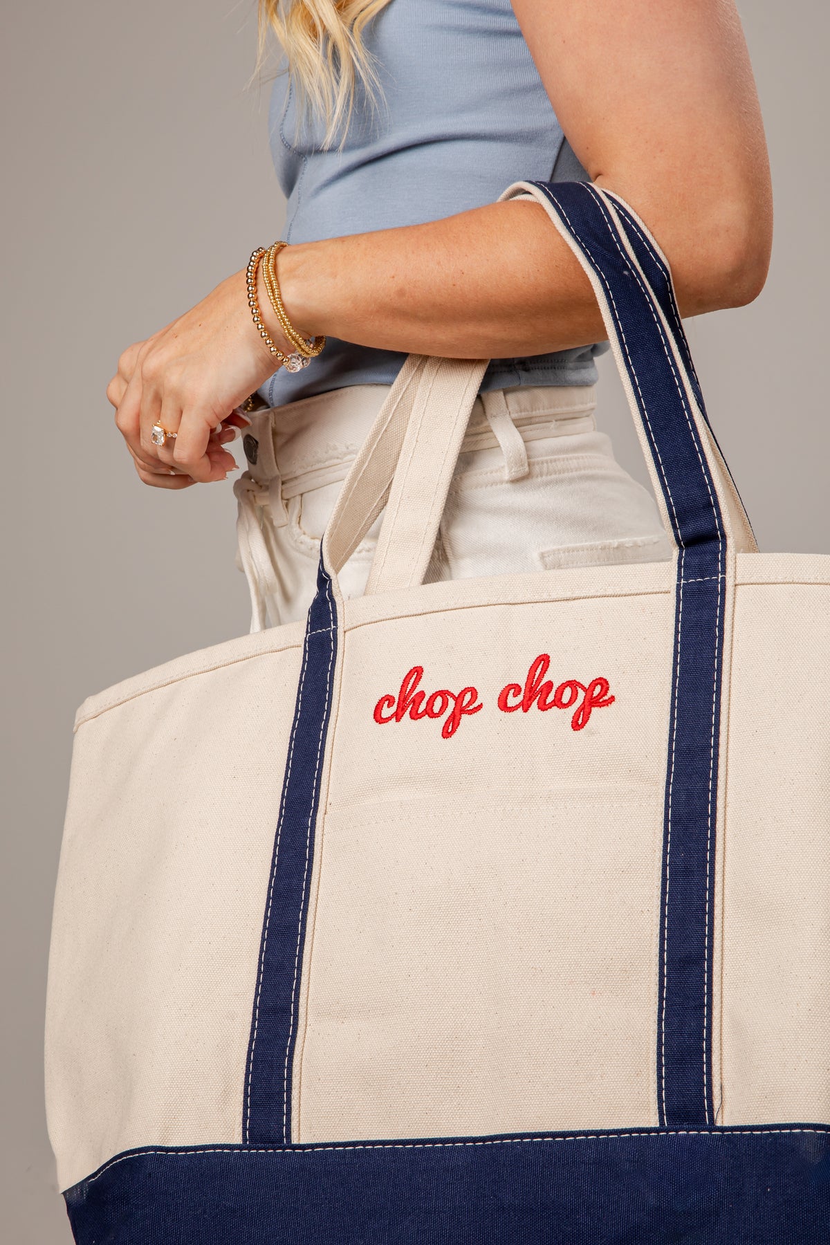 Person holding a tote bag with &