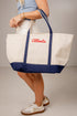 Person holding a tote bag with &