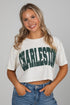 Woman wearing a white crop top with &
