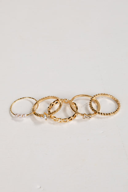 Set of gold rings on a light gray background