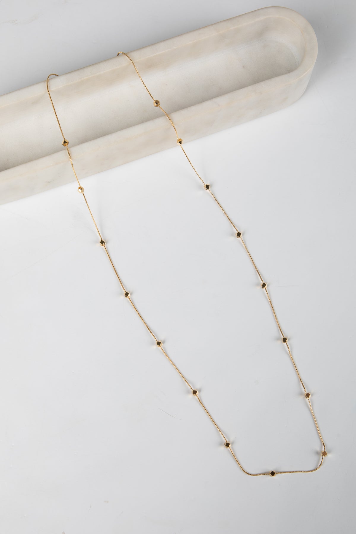 Gold necklace on a white background
