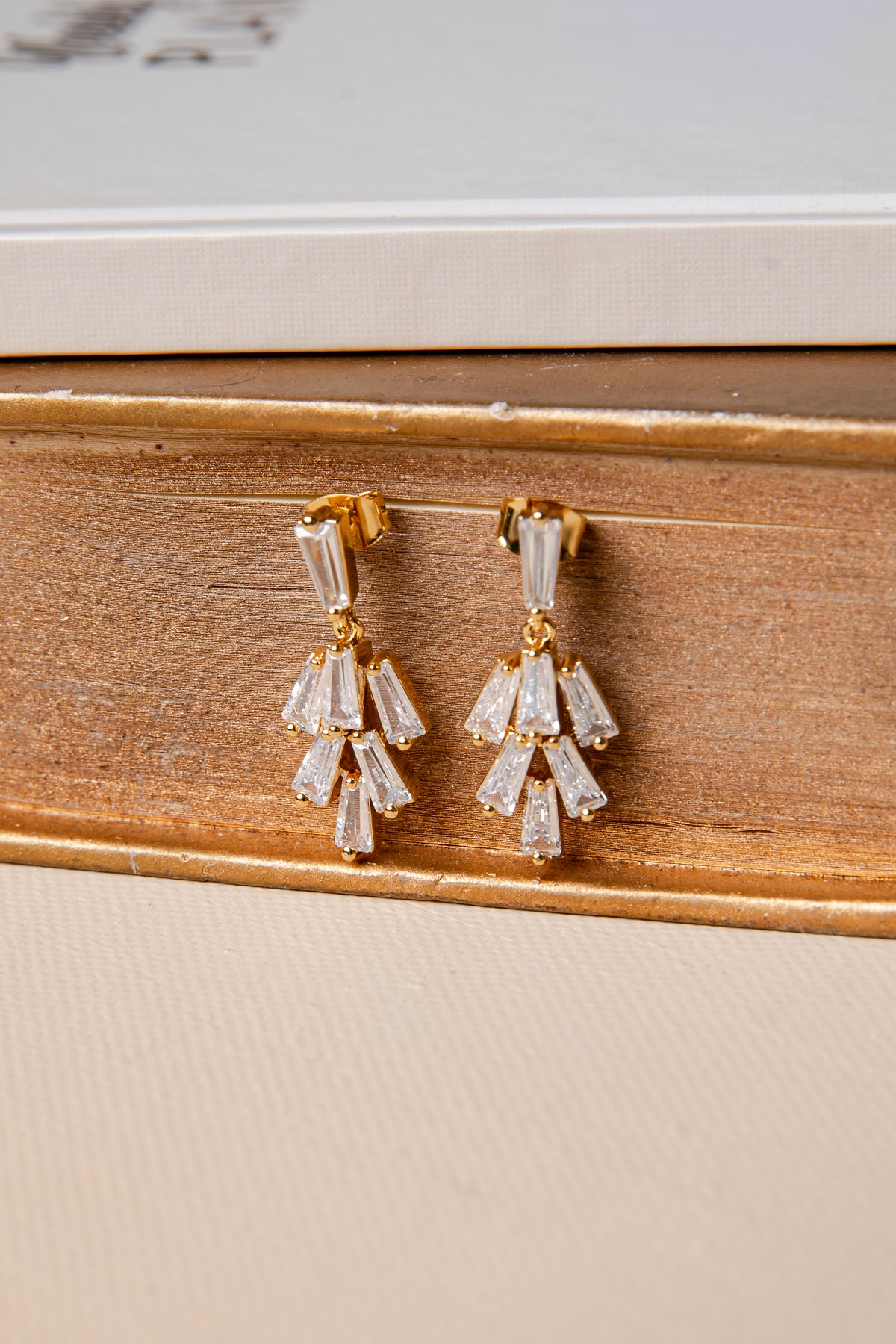 Pair of diamond earrings on a wooden surface