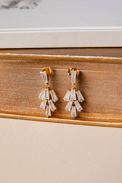 Pair of diamond earrings on a wooden surface
