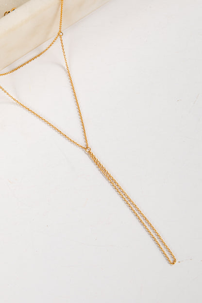 Gold body chain on a white background