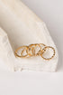 Gold rings on a white fabric surface
