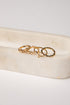 Gold ring with a heart design on a white stone surface