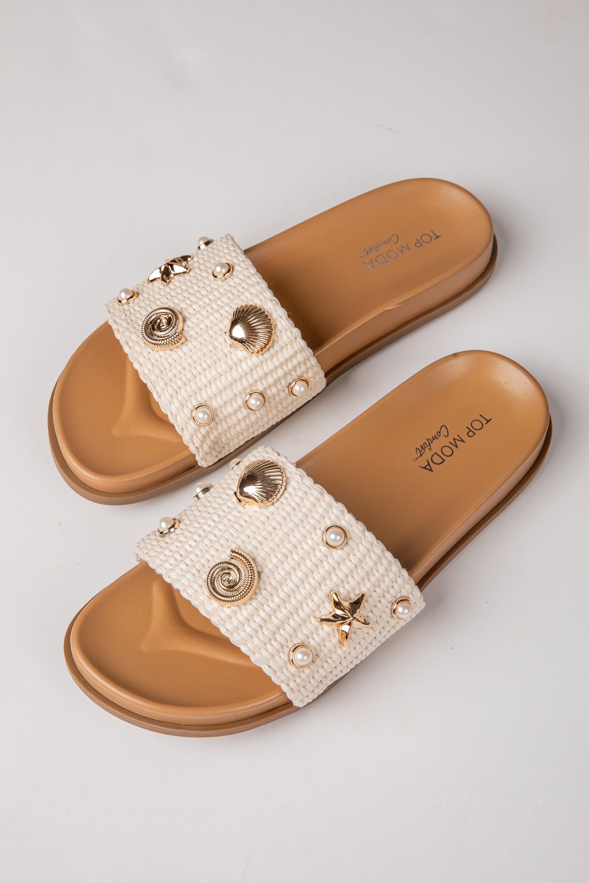 Pair of embellished sandals with a white background