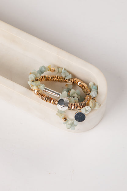 Set of beaded bracelets on a white surface