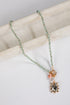 Necklace with gemstone pendant on a marble surface