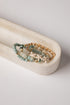 Set of beaded bracelets with starfish charm on a white dish